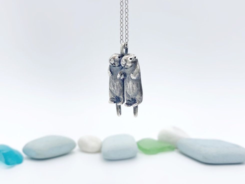 Two Silver Otters Holding Hands Necklace