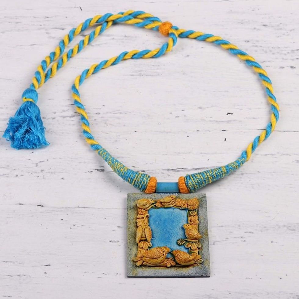 Handcrafted Ceramic Blue and Gold Bird Frame Necklace 'Birdsong'