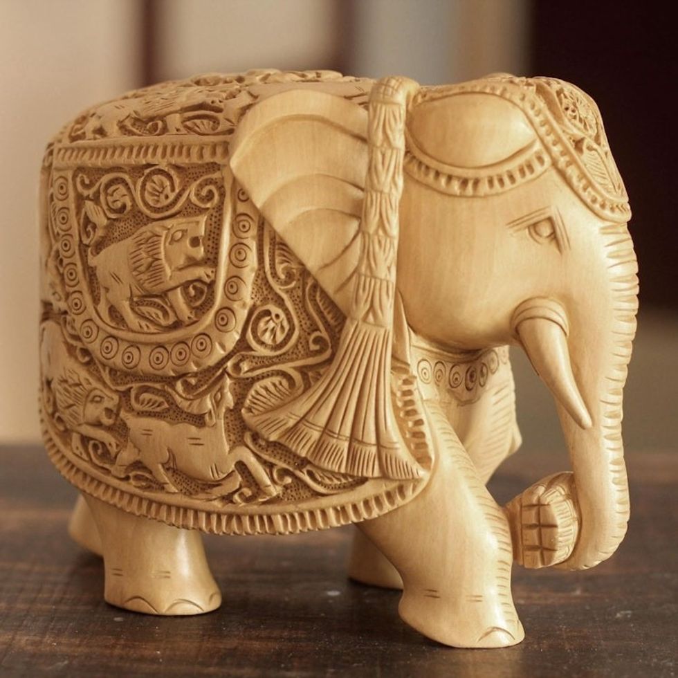 Wood sculpture 'Elephant Goes Hunting'