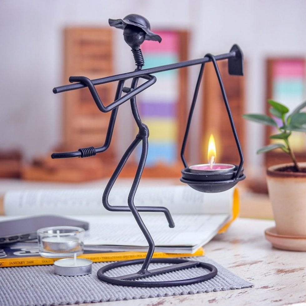 Modern Iron Tealight Holder of Man Carrying Weight in Black 'On my Way'