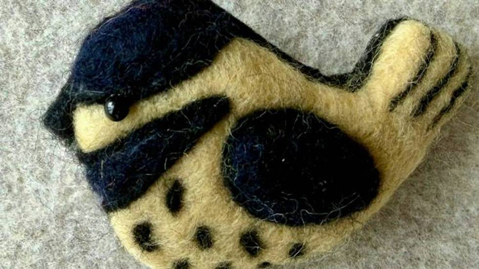 Needle felted wren bird pin, carefully crafted from wool to create a small, lightweight brooch.
