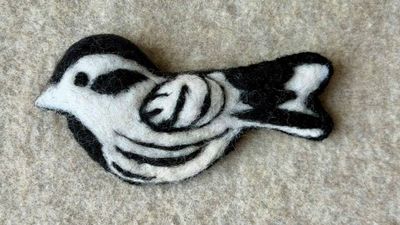 Primary image for Needle felted bird pin, carefully crafted from wool to create a small, lightweight brooch in black and white