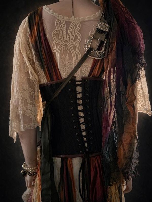 Alternate image for Ragged pirate ensemble with layered skirt, embellished corset, headwear and studded belt